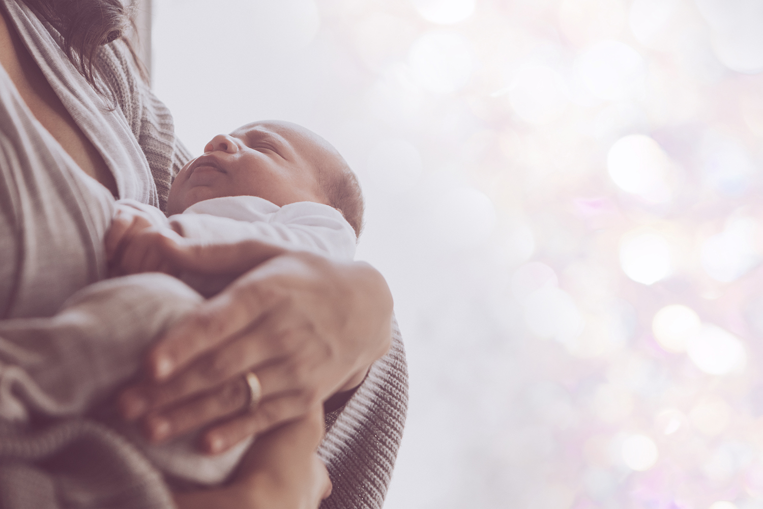 Loving mother cradle holding a newborn baby