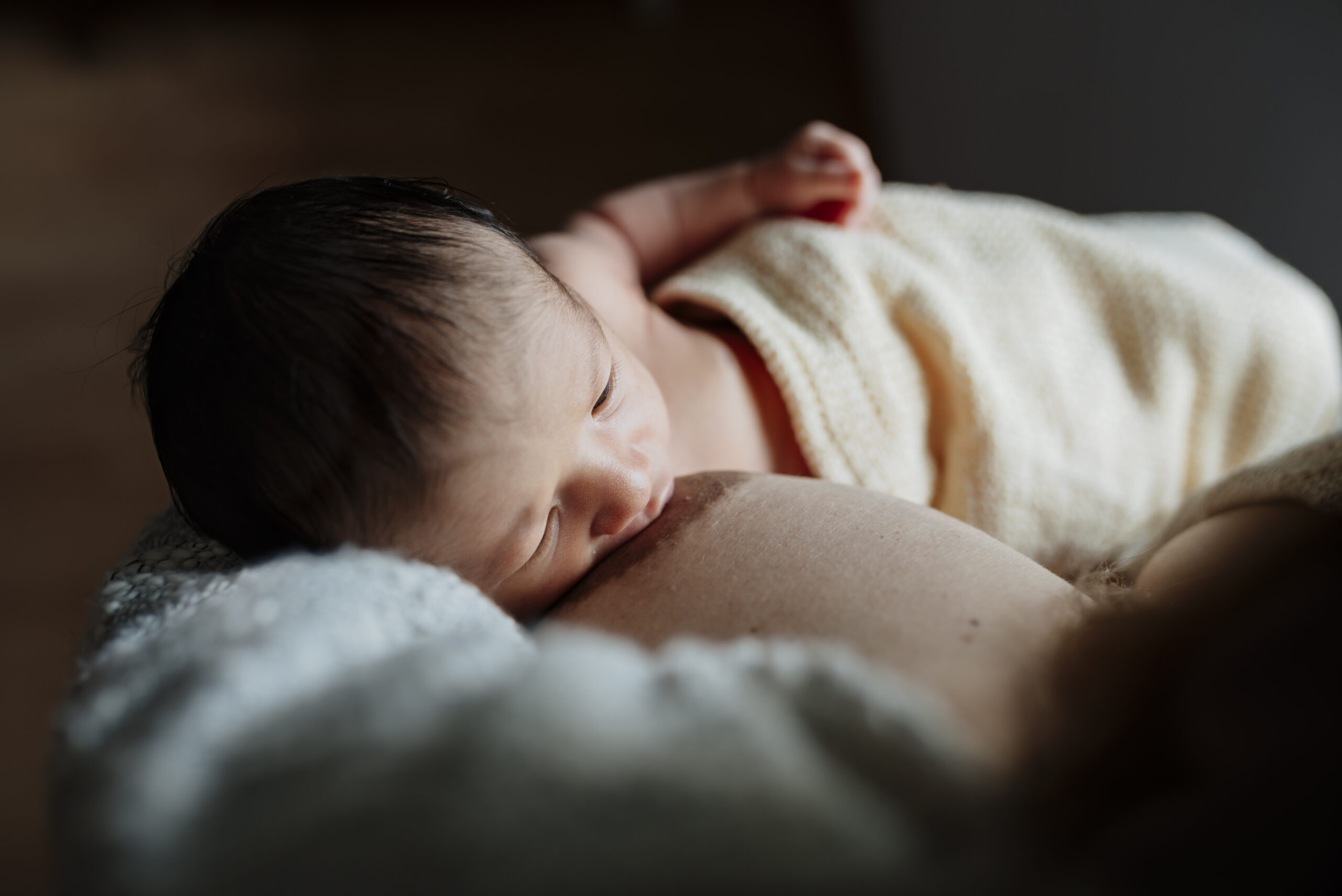 Mother breastfeeding her newborn baby